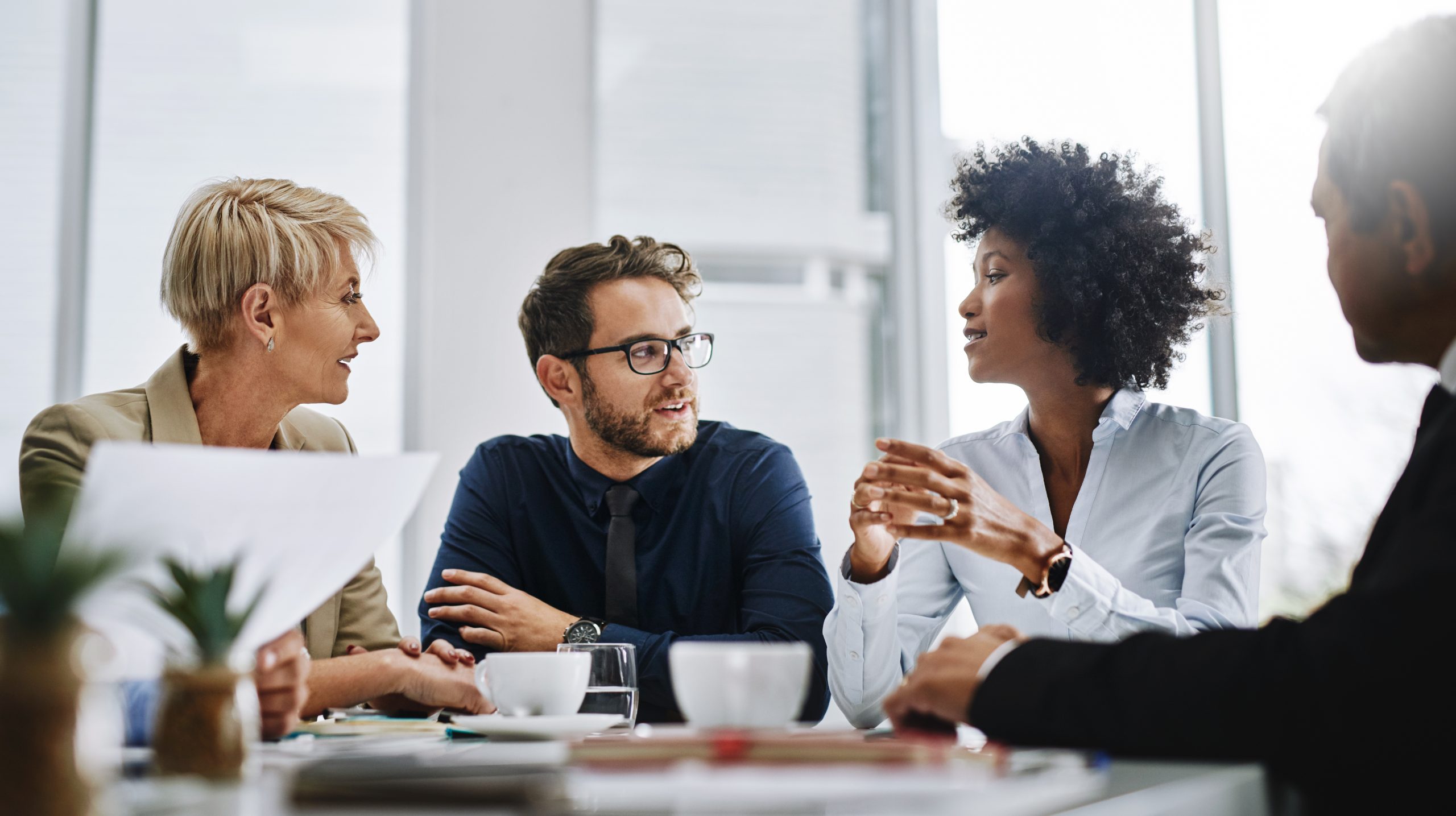 A group of coworkers in conversation around a table