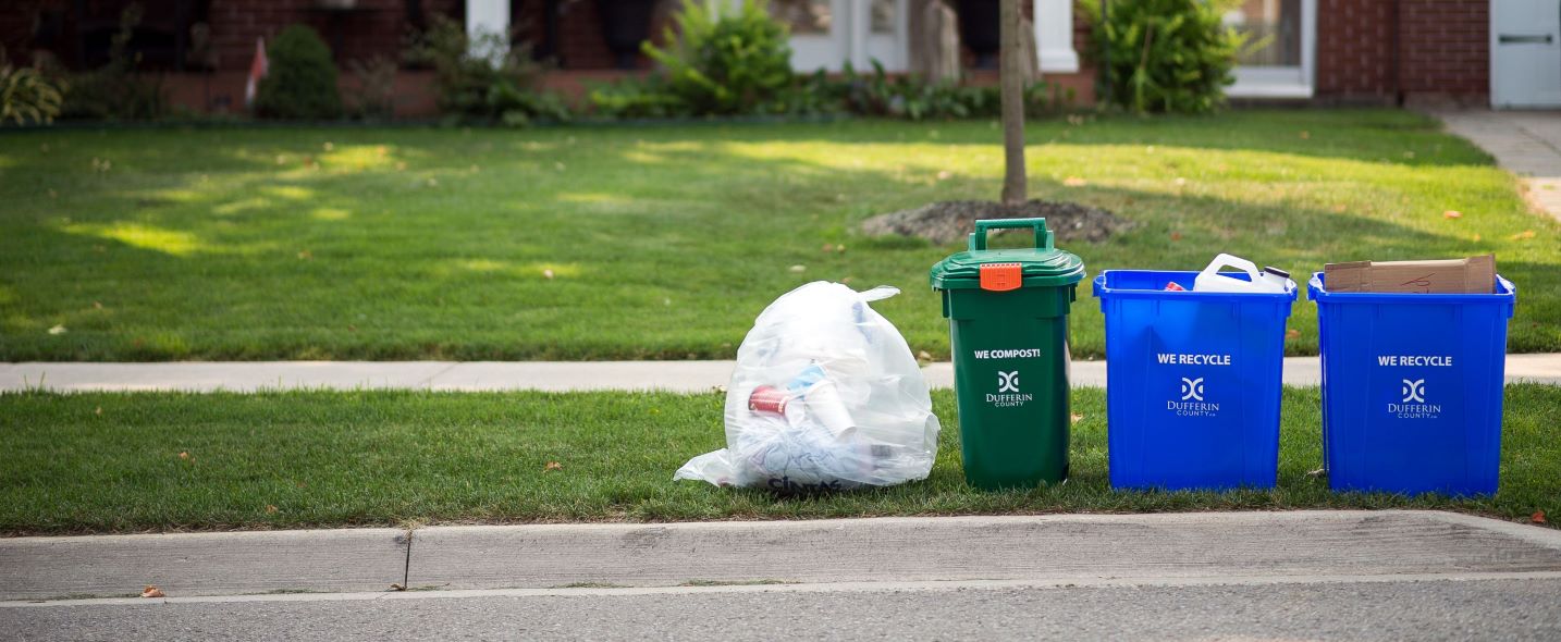 garbage, green bin, blue boxes set out at the curb